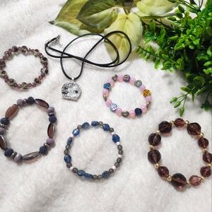 Handmade mostly purple beaded bracelets with a secret door locket charm necklace